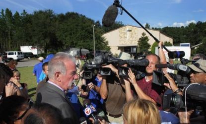 Dove World Outreach Center pastor Terry Jones is surrounded by the media during a press conference.