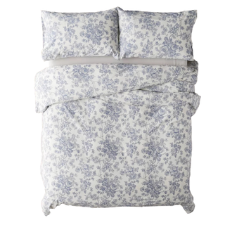 A blue and white toile patterned bedding set