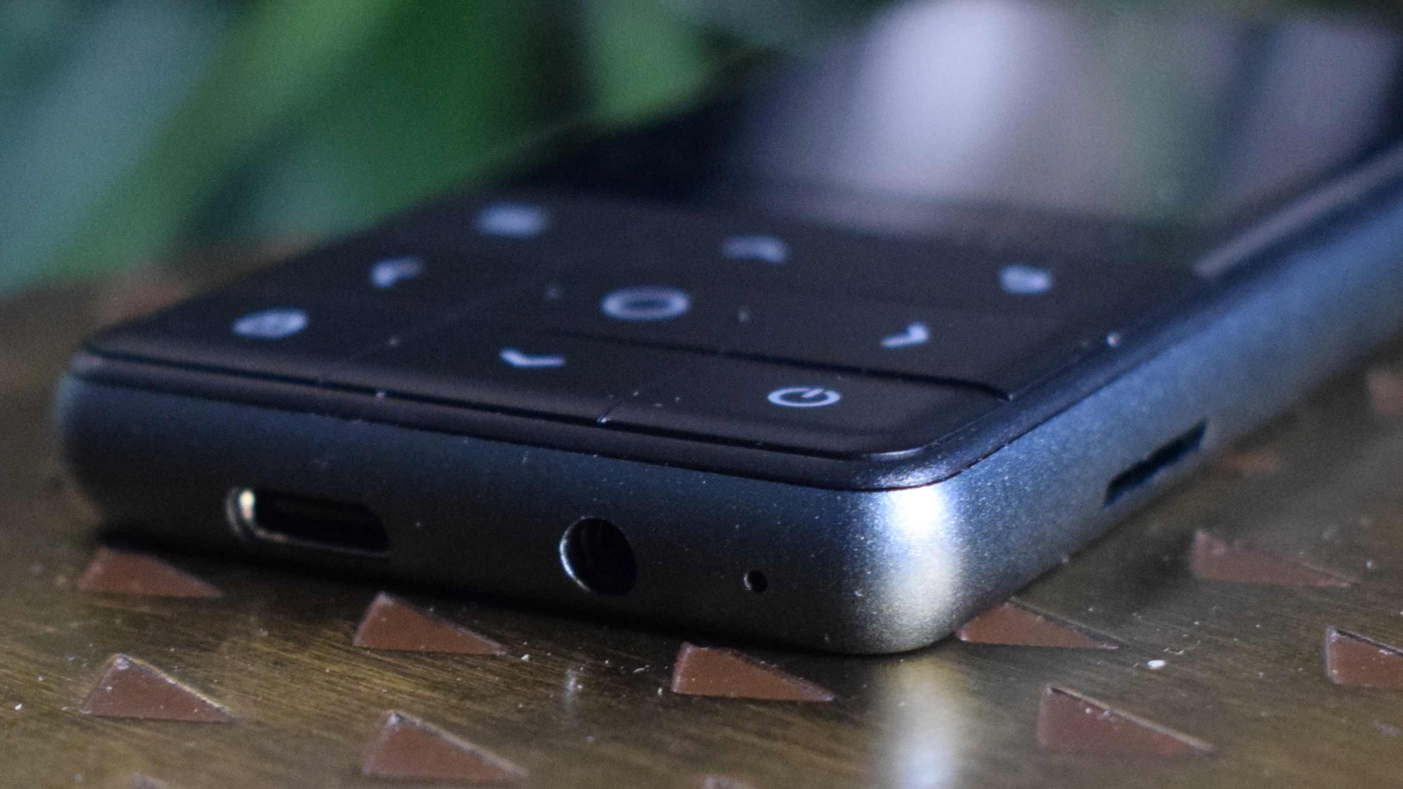 The Oakcastle MP300 laying flat on a table, showing its buttons and ports.