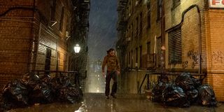 Arthur Fleck trekking through the rain in Joker