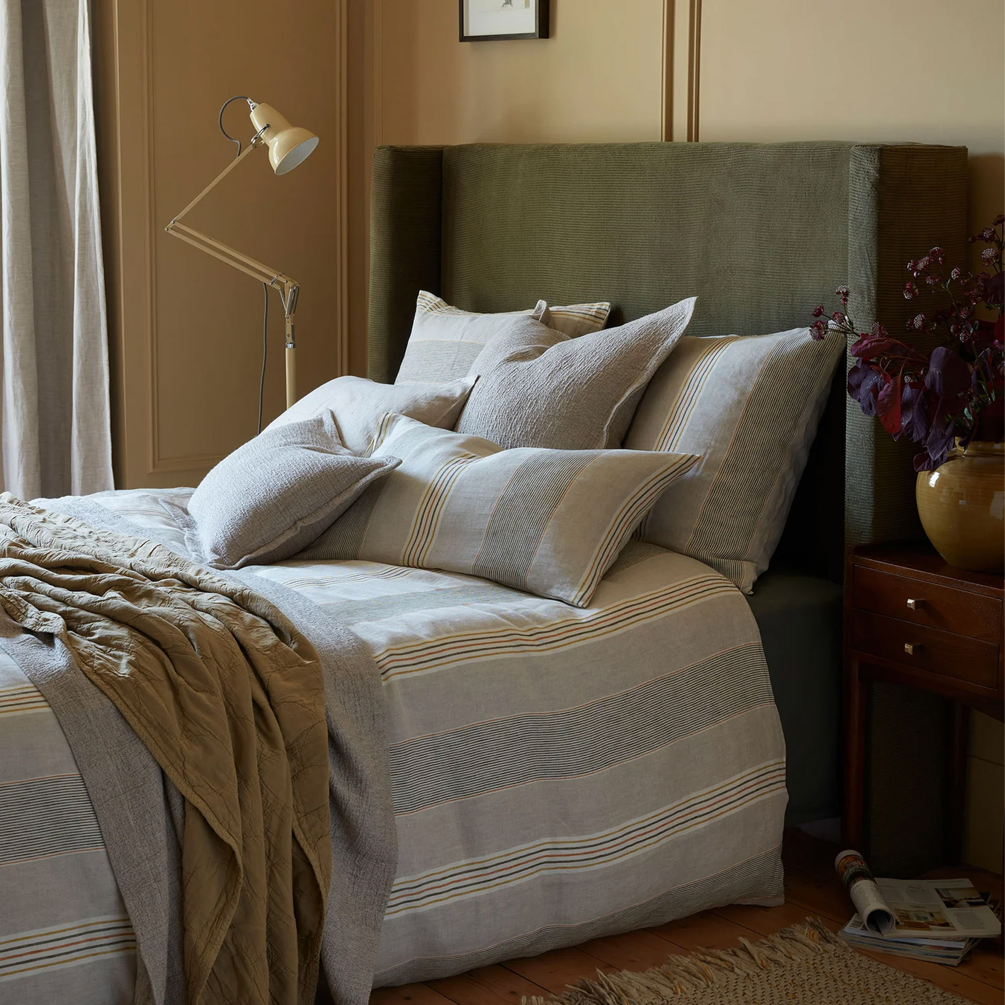 A bed dressed in Secret Linen Store's Sophie Stripe bedding