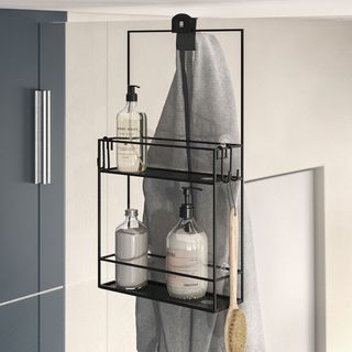 shower storage ideas with glass shower screen and black caddy