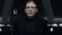 General Hux (Domhnall Gleeson) becomes tense as he receives a transmission from Supreme Leader Snoke in Star Wars: The Last Jedi.