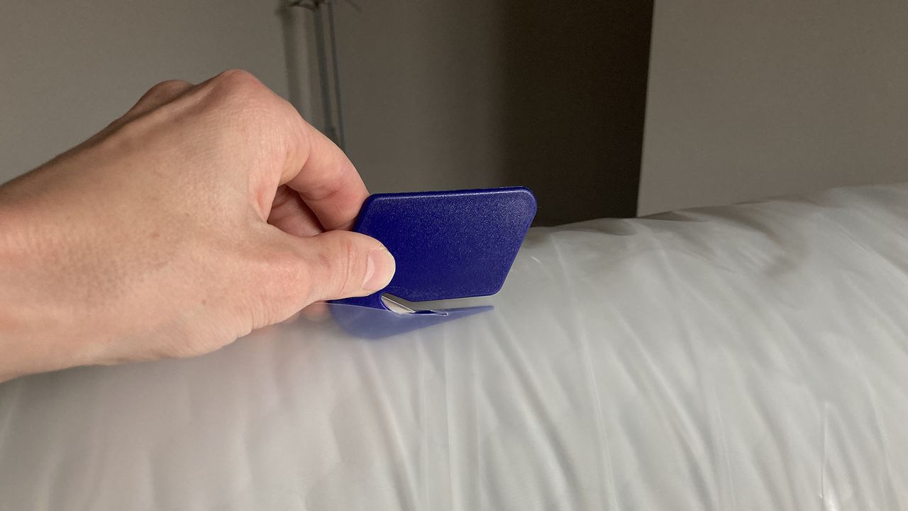 Lola Cool Hybrid mattress in plastic, being sliced open