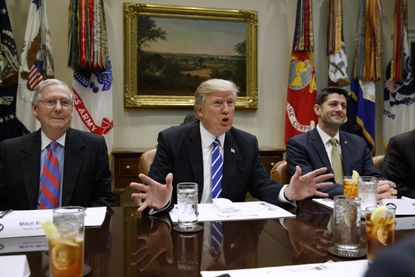 President Trump flanked by Paul Ryan and Mitch McConnell. 