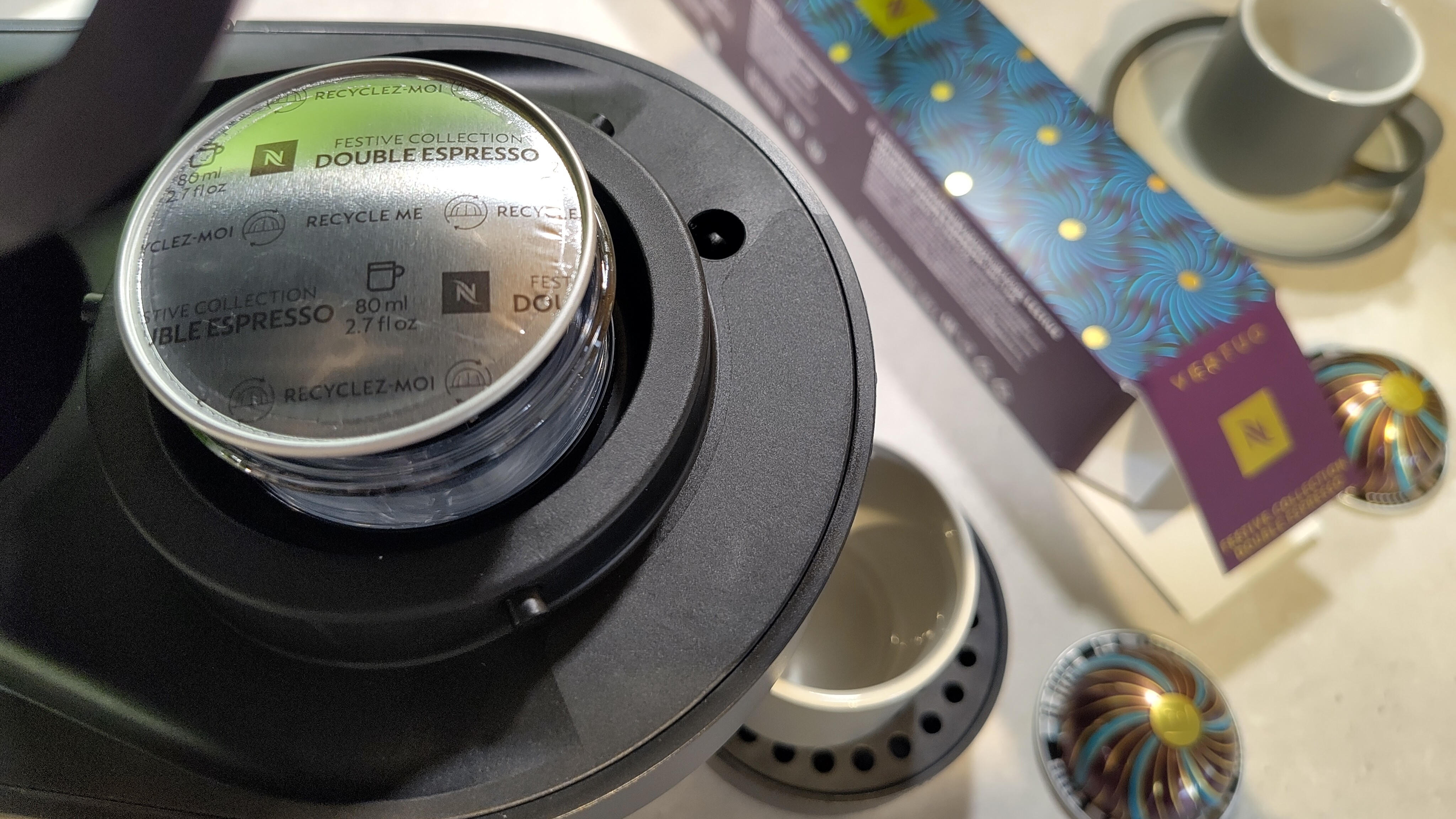 Nespresso Festive Collection Double Espresso capsule inserted in Nespresso Vertuo Pop machine