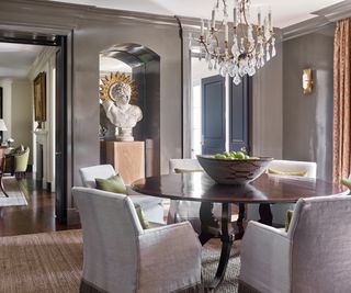 dining room with gloss walls round table and chandelier