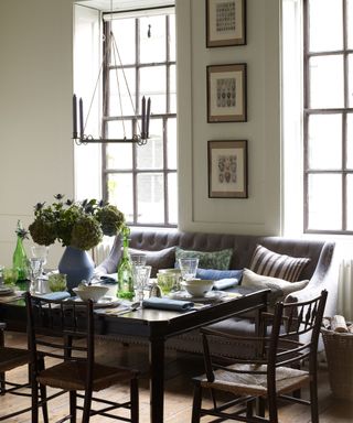 Dining room with dark wood table and chairs an upholstered banquette