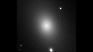 an image of the largest galaxy, IC 1101, shown as a diffuse white glow