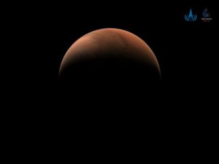 China's Tianwen-1 spacecraft orbiting Mars captured this stunning view of a crescent Red Planet on March 18, 2021. Shown here is the planet's northern hemisphere from a distance of 6,850 miles (11,000 kilometers).