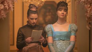 Hyacinth looking down at a copy of Lady Whistledown while Eloise looks off into the distance. 