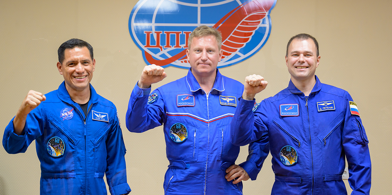 Frank Rubio of NASA and Sergey Prokopyev and Dmitri Petelin of Roscosmos are seen in quarantine, behind glass, during a pre-launch press conference on Sept. 20, 2022.