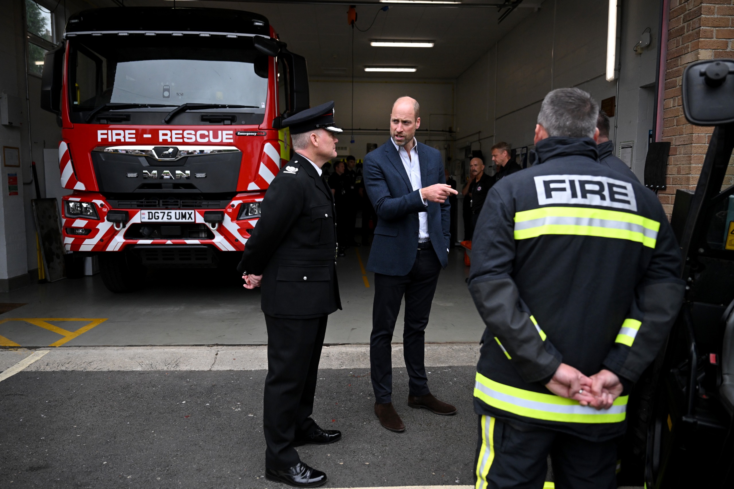 Prince William talking to fire fighters at a station