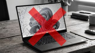 A greyscale laptop showing a Windows 11 screen with a red cross on it