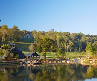 home exterior with lake and trees