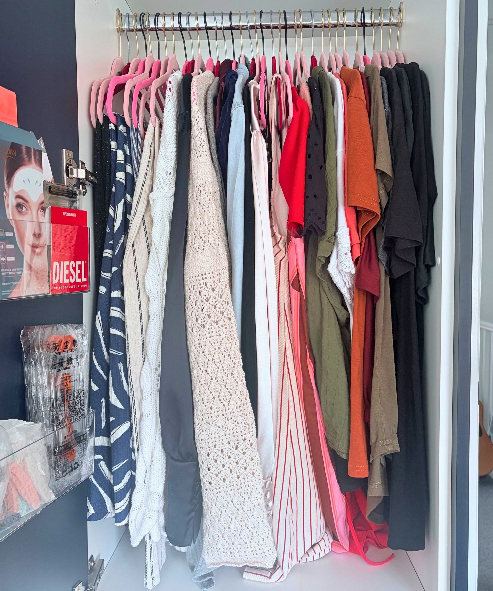 My compact closet after decluttering for spring and summer, which shows around 25 hangers worth of light clothing in a small hanging space