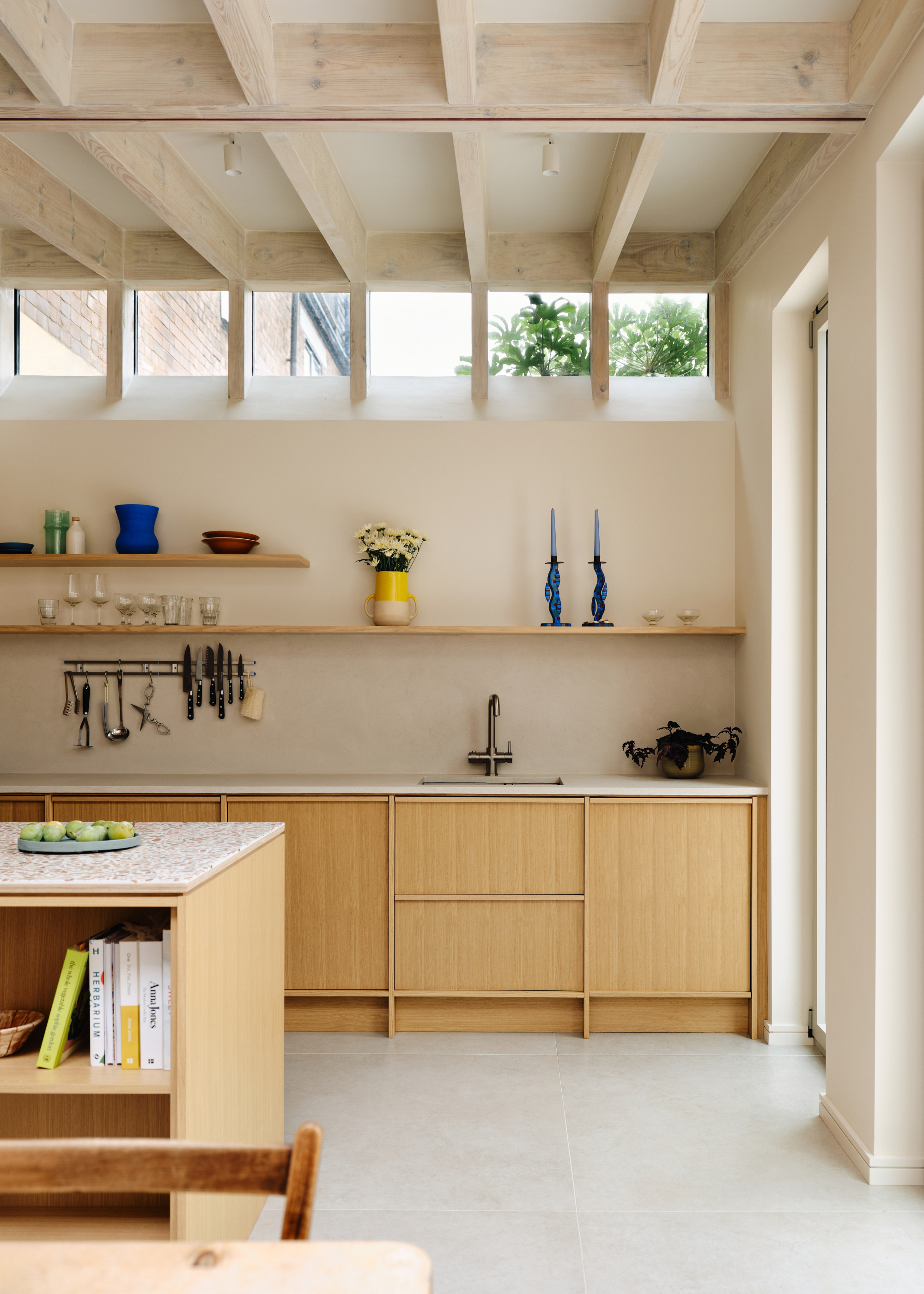 bright kitchen with beams on the ceiling and light wooden, expressed cabinetry