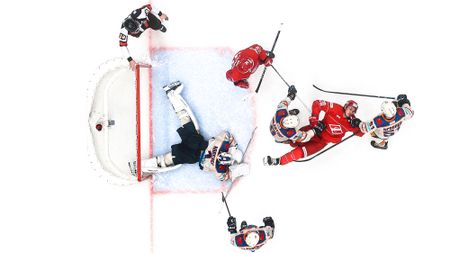 Top-down view of ice hockey goal and players 