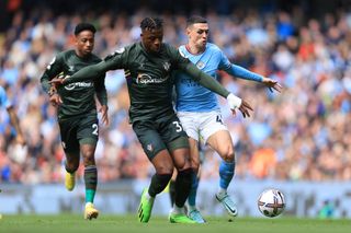 Armel Bella-Kotchap of Southampton battles with Phil Foden of Manchester City during the Premier League match between Manchester City and Southampton FC at Etihad Stadium on October 8, 2022 in Manchester, United Kingdom.