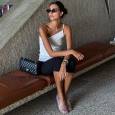 Woman in jelly shoes, capri pants and white top