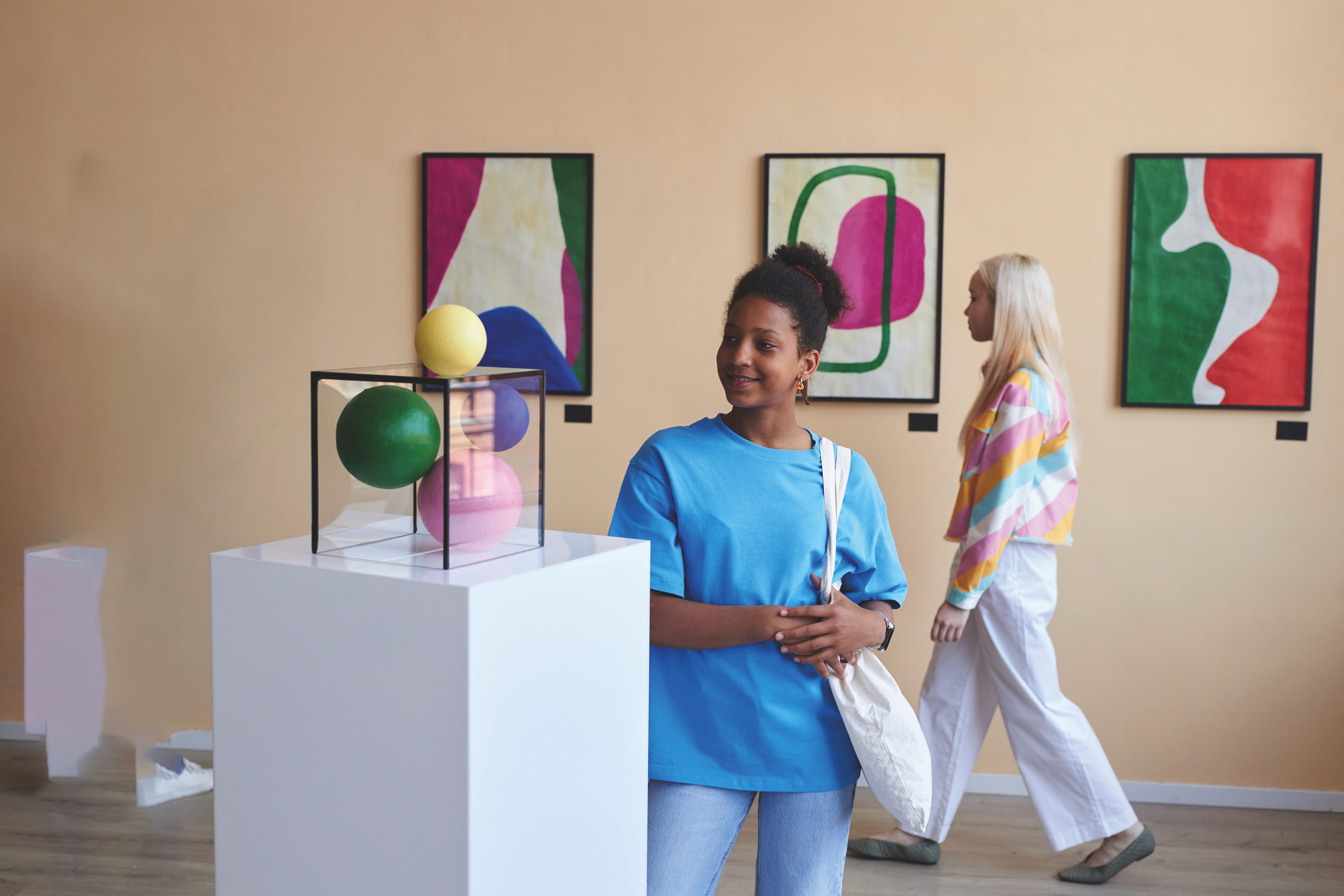 Woman looking at an abstract sculpture at an art gallery