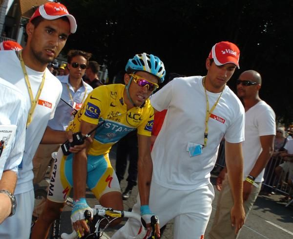 Alberto Contador (Astana) is helped to the podium.