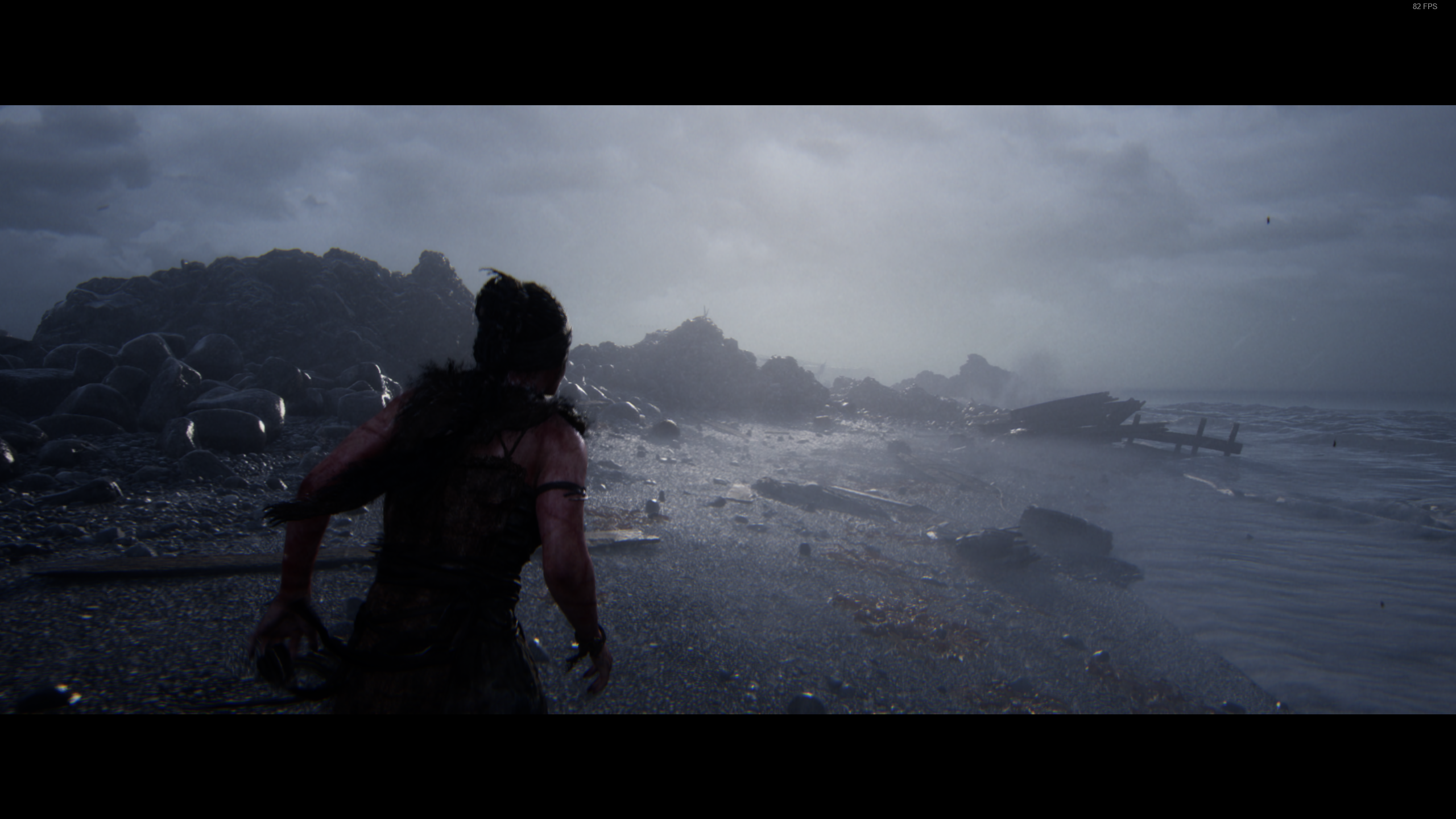 A screenshot from Senua's Saga: hellblade 2, showing Senua running on a foggy beach with XeSS enabled
