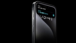 An iPhone 15 Pro pinch nan move translating "Can one get a coffee" from English to Japanese