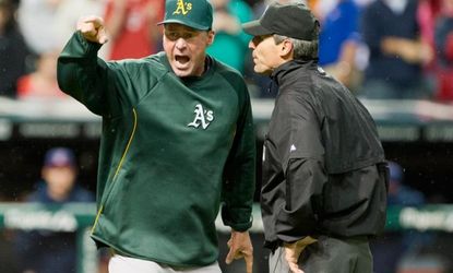 Oakland A's manager Bob Melvin yells at umpire Angel Hernandez after a game-tying home run was wrongly called a double.