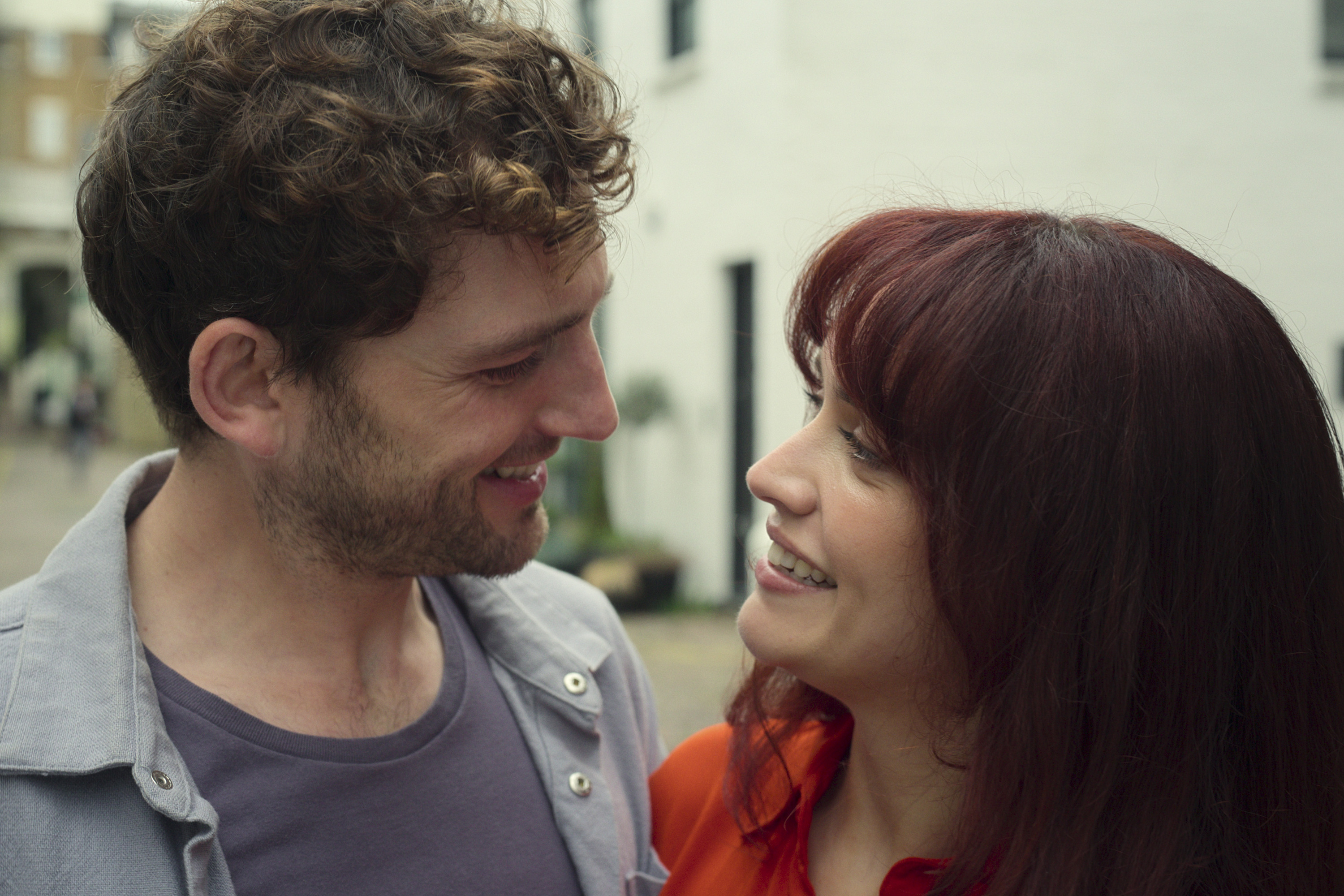 Laurie Davidson as daniel and olivia cooke as cherry smiling at each other in the girlfriend