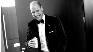 Prince William, Prince of Wales laughs as he drinks some water backstage during the 2023 Earthshot Prize Awards Ceremony