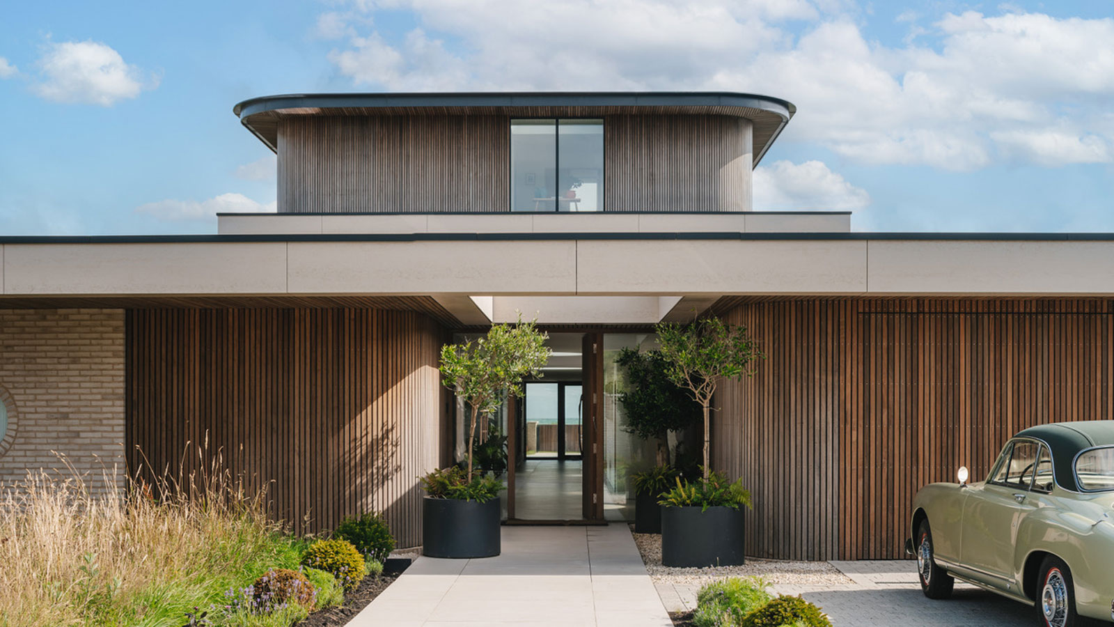 contemporary house with vertical timber cladding and curved walls
