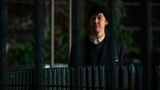 Will (Alex Sharp) stands by a fence in 3 Body Problem