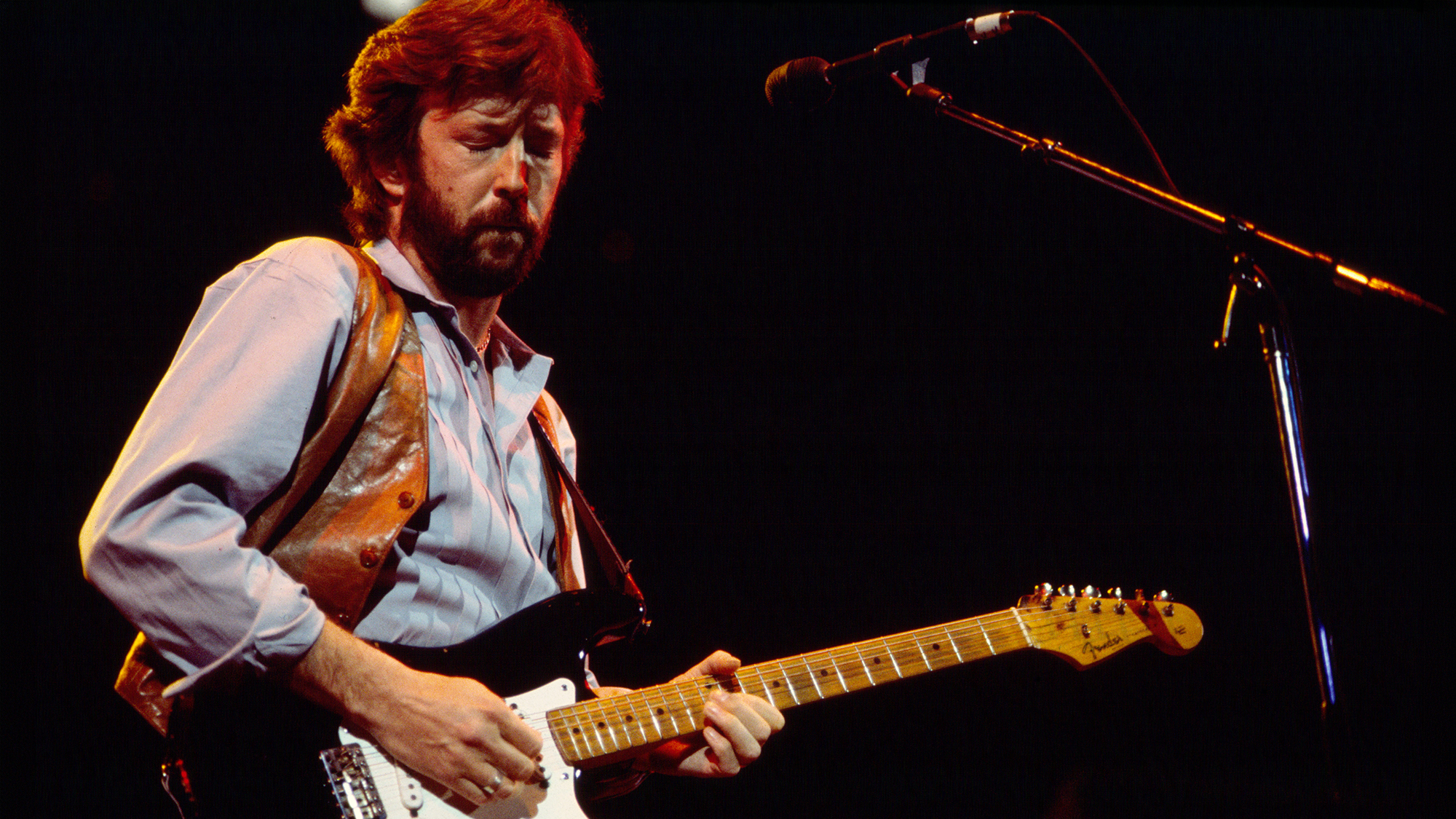 Eric Clapton plays guitar as he performs onstage during his 'Money and Cigarettes' tour at Brendan Byrne Arena (later renamed Meadowlands Arena), East Rutherford, New Jersey, February 22, 1983.