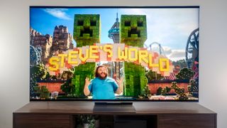 A TCL QM9K TV on a side table