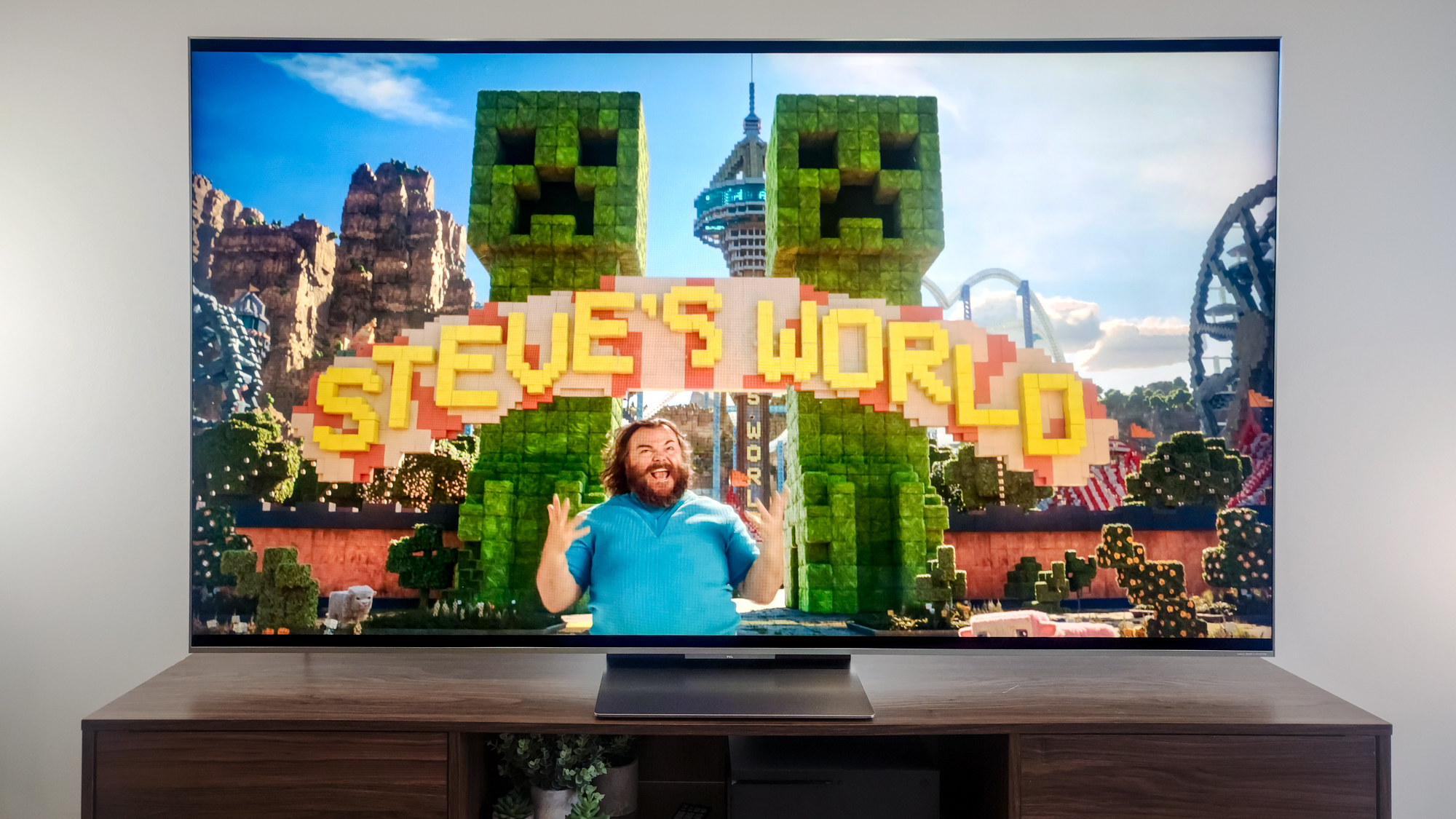 A TCL QM9K TV on a side table