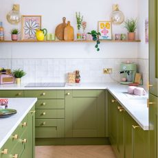 Green kitchen makeover with white tiles and wooden shelf