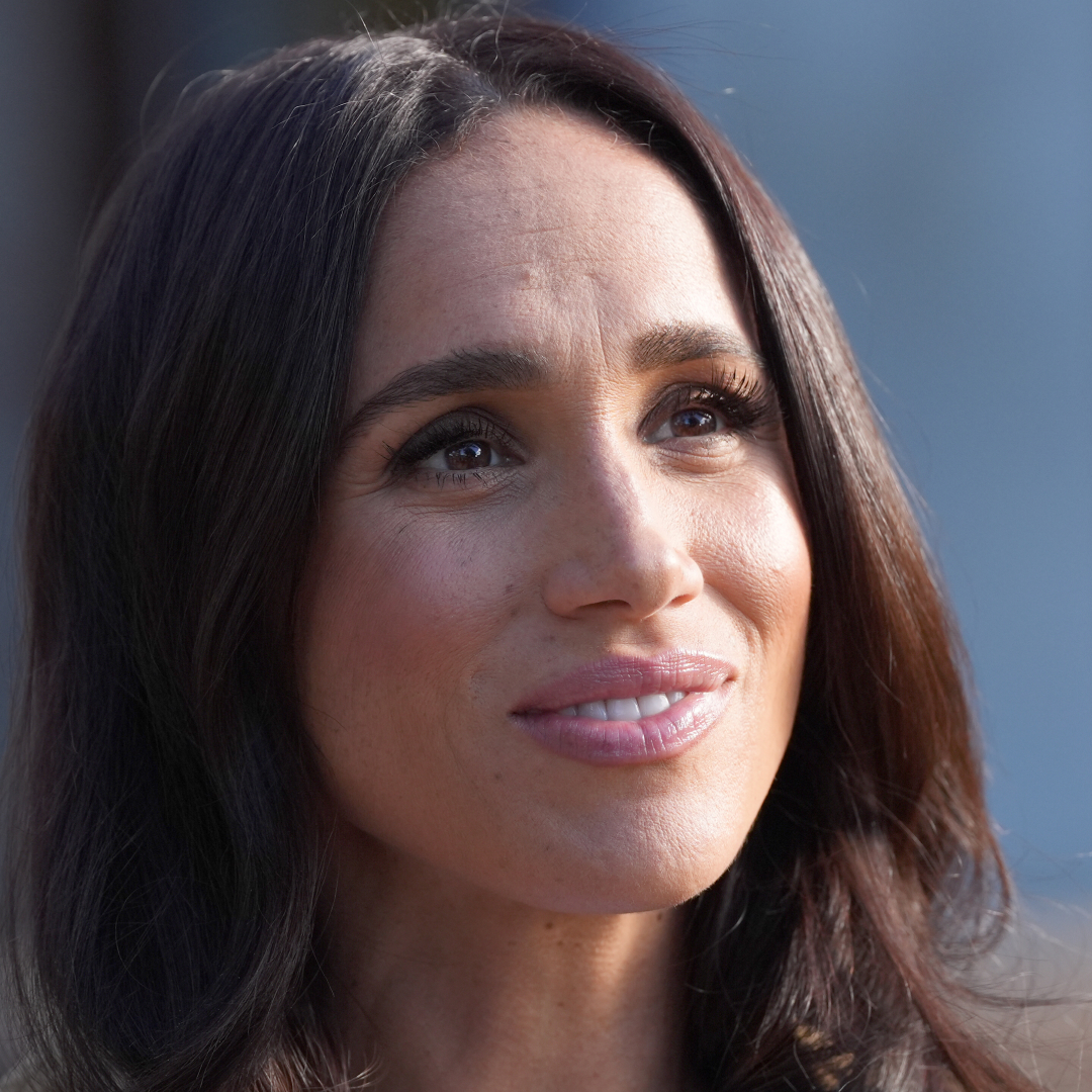 A headshot of meghan markle smiling