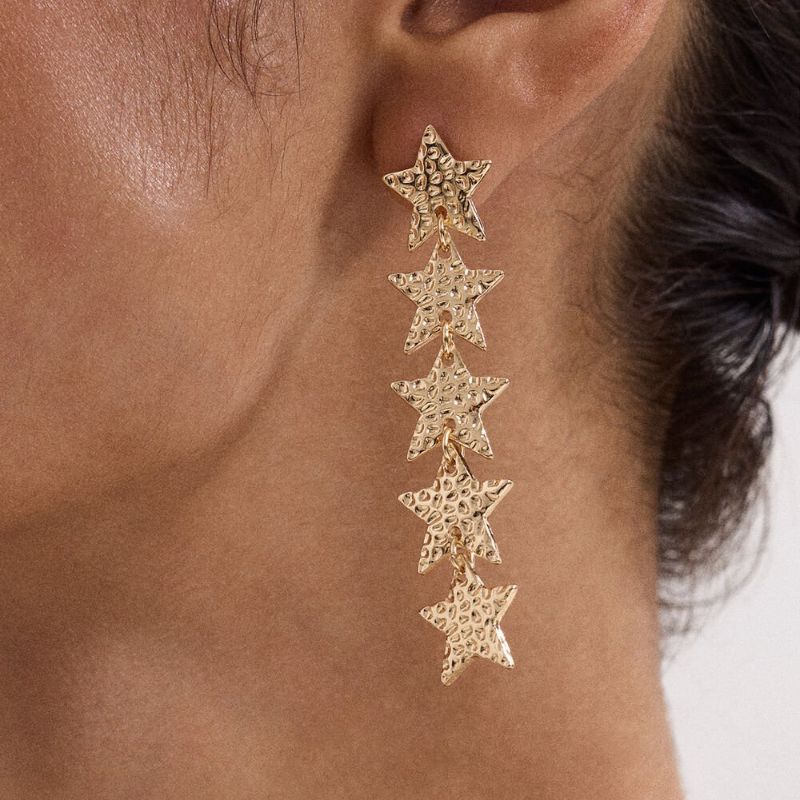 Star drop earrings on model 