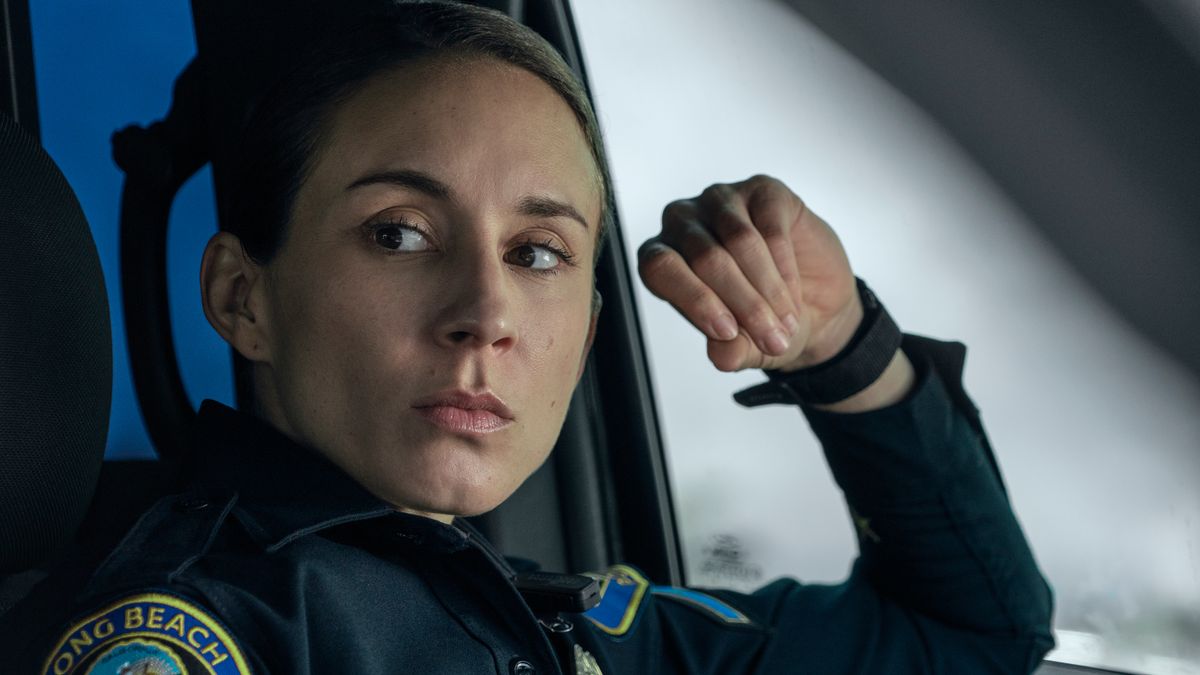 Traci Harmon (Troian Bellisario) sitting inside a cop car in Prime Video&#039;s &quot;On Call&quot;