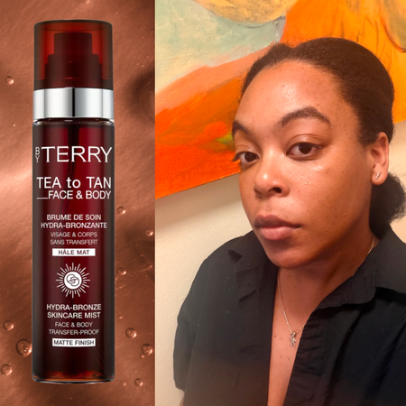 A woman in a black top with her hair pulled back looking at the camera to show her bronzed skin. She is next to a bottle of bronzing water called Tea to Tan from By Terry. 