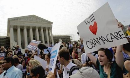 Supporters of President Obama's health care law celebrate outside the Supreme Court in Washington on June 28: According to the Congressional Budget Office, the court's ruling, which allows st
