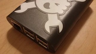 A close up image of a USB hub with a skull and crossbones sticker attached