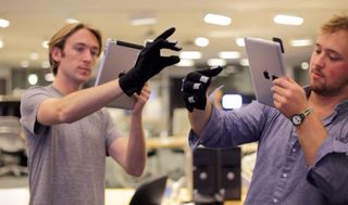 MIT's gloves allow wearers to work together in the same virtual space.