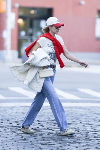 Red jumper trend: Gigi Hadid wears a red jumper over her shoulders