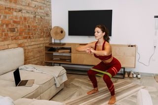 Best bodyweight leg workout: a woman working out at home