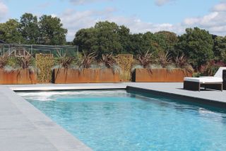 modern swimming pool with corten raised planters