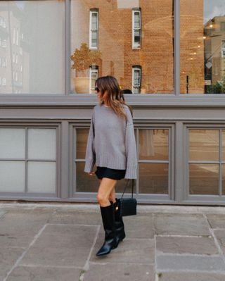 @kimturkington_ wears a grey jumper, black miniskirt and knee-high boots