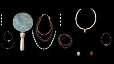 A collection of jewelry and other artifacts against a black background