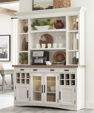 White shelving unit with coffee maker and dishes